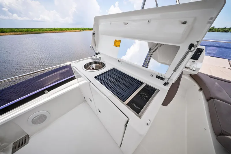 Slide: The Image of Outdoor kitchenette on 2017 Prestige 560 Flybridge yacht with sink and grill. - 23
