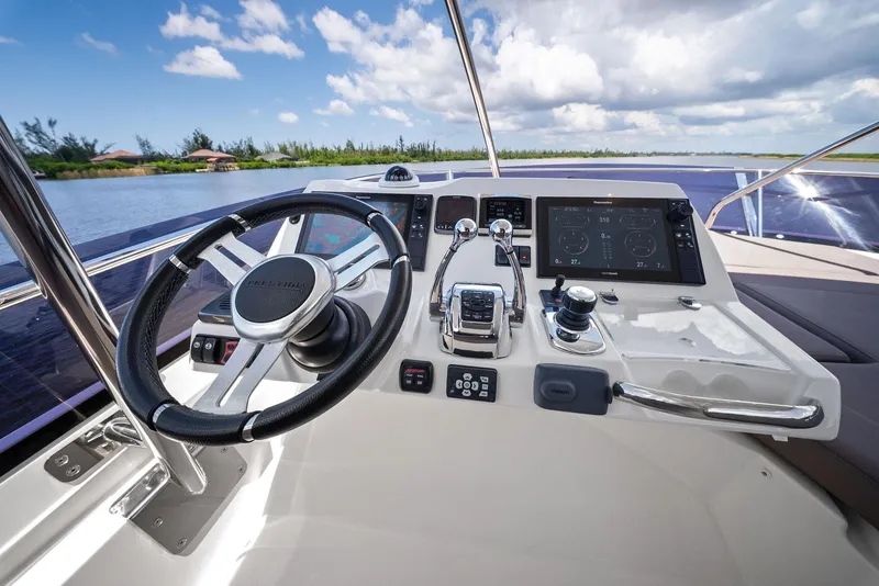 Slide: The Image of Prestige 560 Flybridge 2017 yacht helm with modern controls and scenic water view. - 25