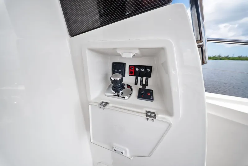 Slide: The Image of Control panel of a 2017 Prestige 560 Flybridge yacht, featuring joystick and switches. - 33