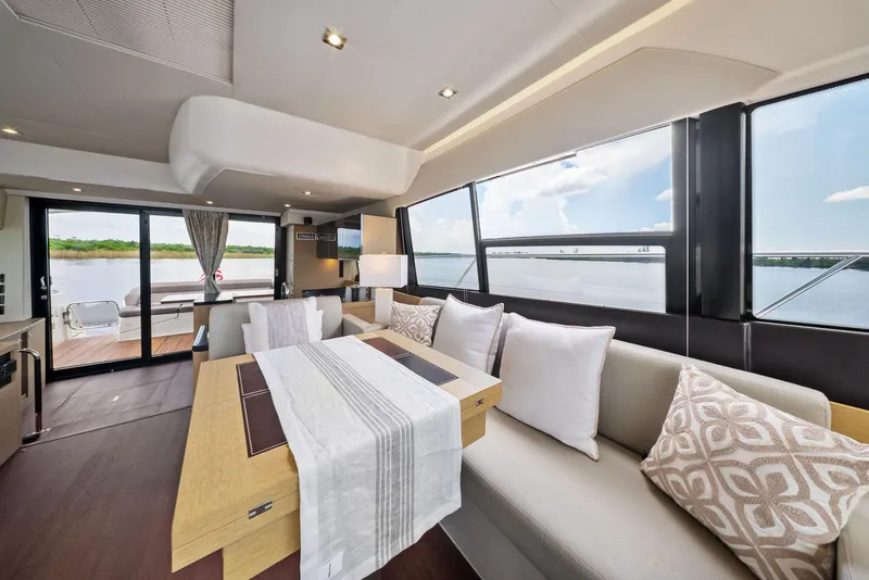 Slide: The Image of Luxurious interior of 2017 Prestige 560 Flybridge yacht with elegant dining area and scenic views. - 37