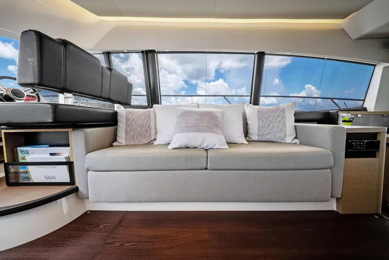 Slide: The Image of Luxurious interior of 2017 Prestige 560 Flybridge yacht with plush seating and panoramic windows. - 46