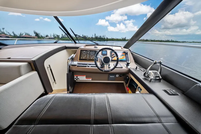 Slide: The Image of Luxurious 2017 Prestige 560 Flybridge yacht helm with modern controls and panoramic view. - 48
