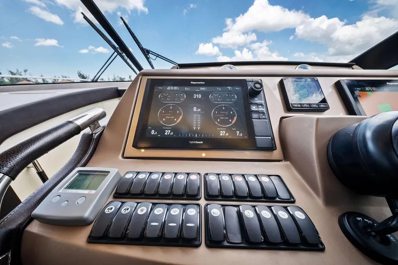 Slide: The Image of Control panel of 2017 Prestige 560 Flybridge yacht with navigation screens and switches. - 49