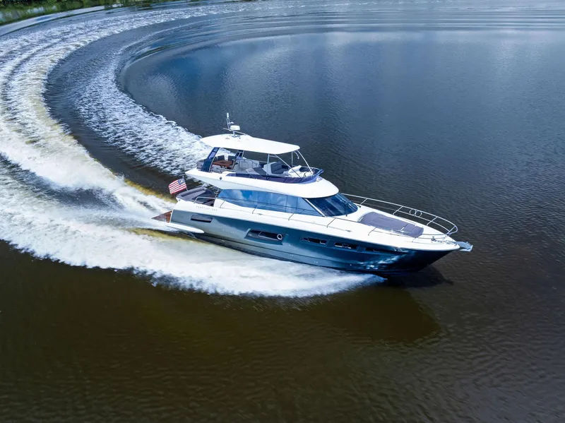 Slide: The Image of 2017 Prestige 560 Flybridge yacht cruising on calm waters. - 5