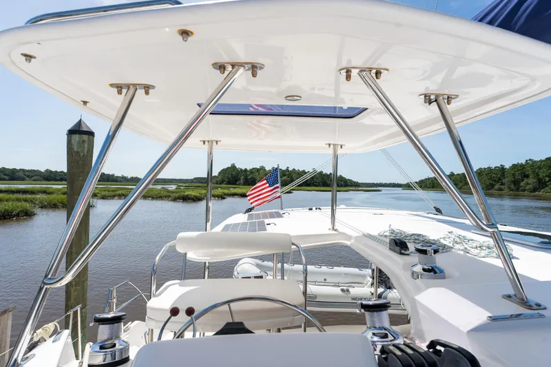 Slide: The Image of 2016 Leopard 44 Owners Version catamaran with enclosed cockpit on calm water. - 14