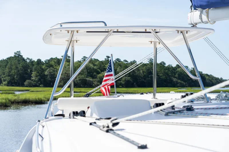 Slide: The Image of 2016 Leopard 44 Owners Version catamaran on calm water, showcasing deck and sail details. - 16