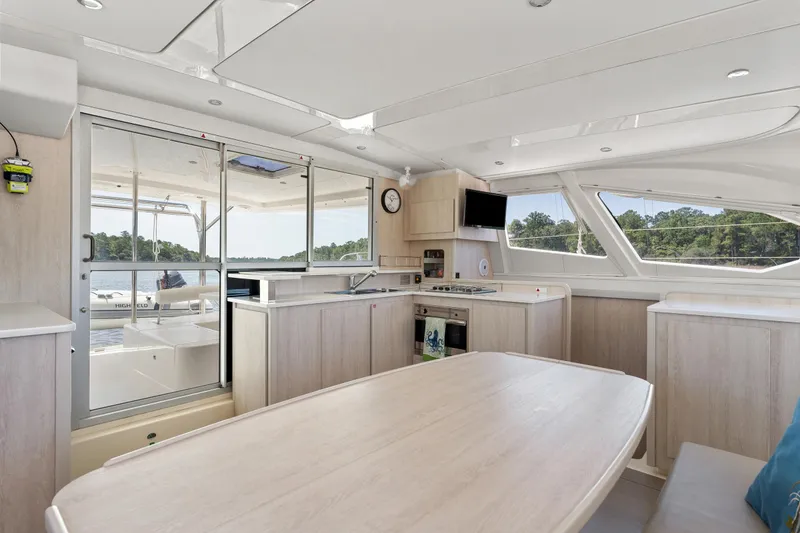 Slide: The Image of Sailing rope clutches labeled "Topping Lift," "Main Halyard," and "Genoa 2" on Leopard 44 yacht. - 27