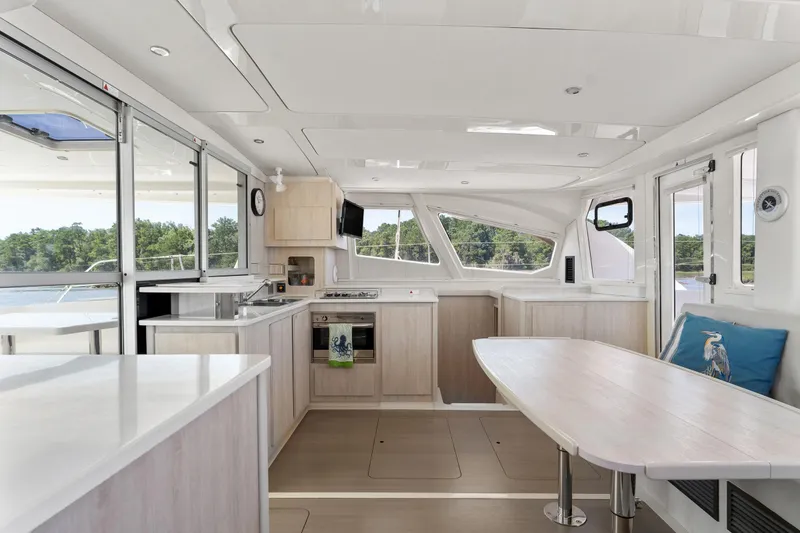 Slide: The Image of 2016 Leopard 44 Owners Version yacht interior with outdoor seating and scenic water view. - 30