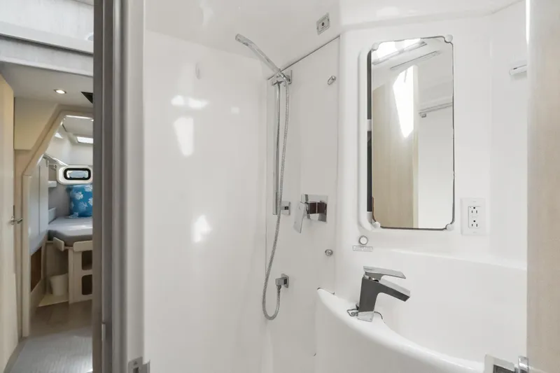 Slide: The Image of Cozy cabin interior of 2016 Leopard 44 Owners Version with blue pillows and ample natural light. - 42