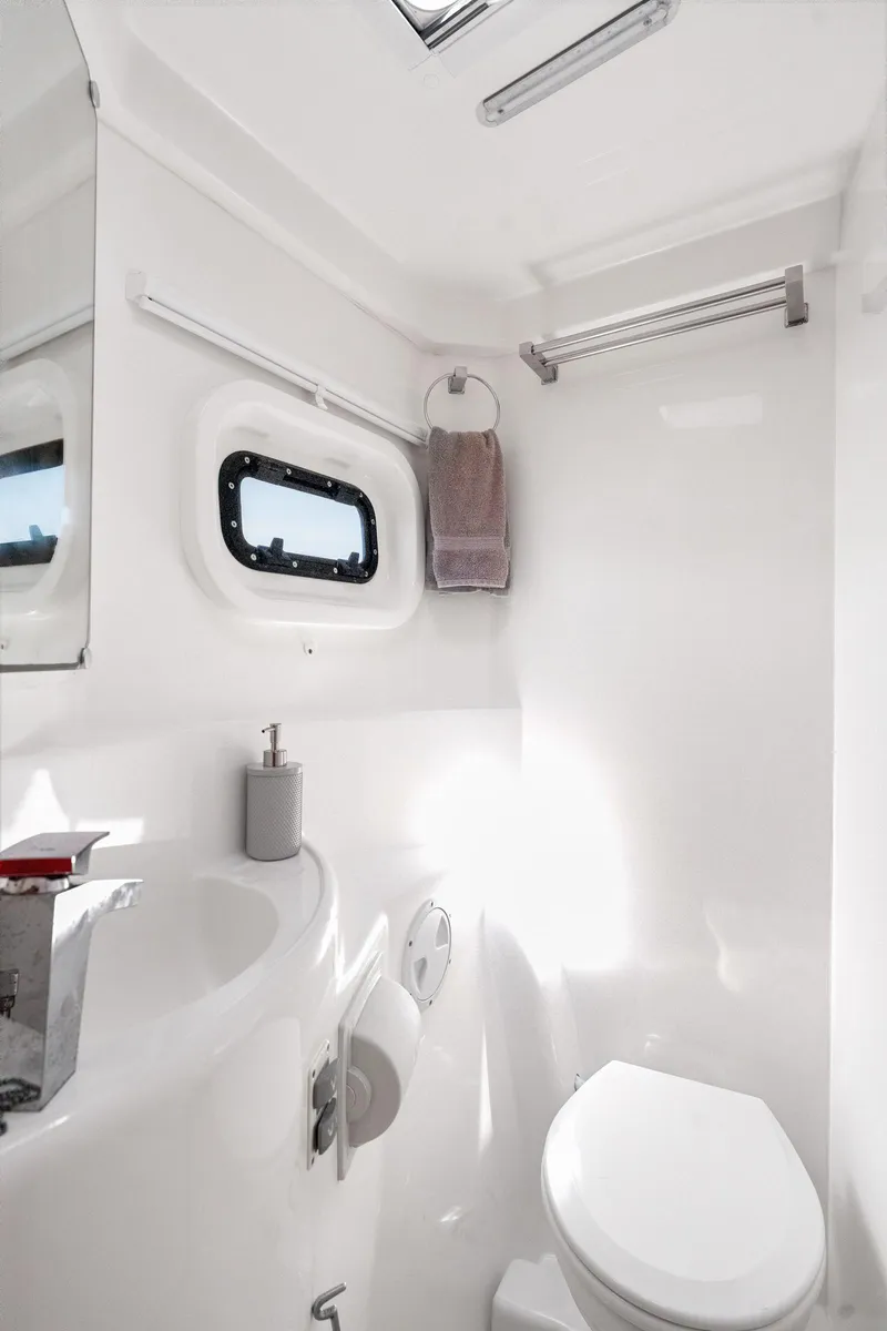 Slide: The Image of Interior of 2016 Leopard 44 Owners Version yacht, featuring a cozy bedroom with a window view. - 43