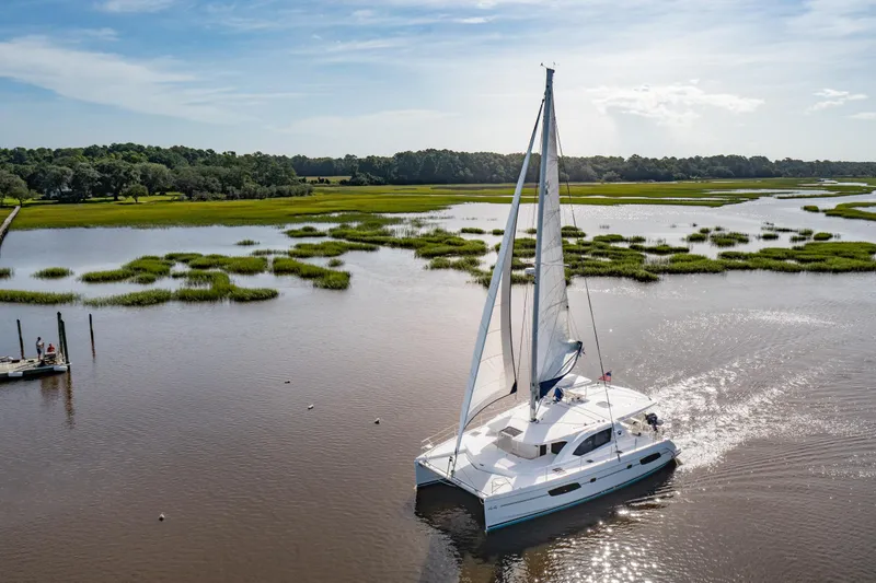 Slide: The Image of 2016 Leopard 44 Owners Version catamaran sailing in serene marshland waters. - 6