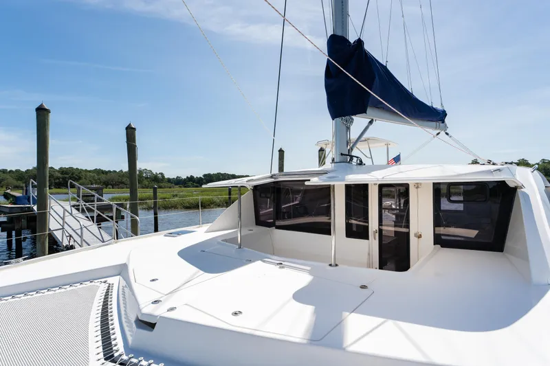 Slide: The Image of 2016 Leopard 44 Owners Version catamaran docked, featuring spacious deck and sleek design. - 9