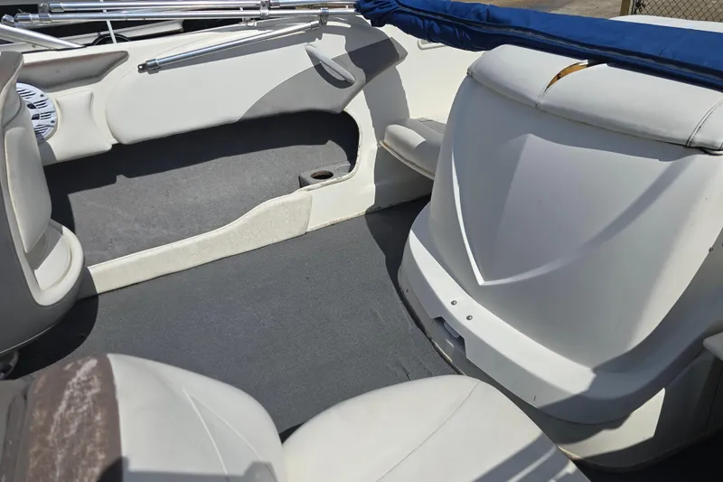 Slide: The Image of Interior of a 2010 Bayliner 185 Bowrider boat, featuring seating and storage areas. - 10