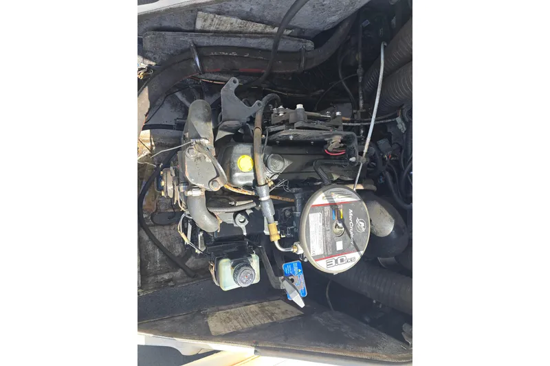 Slide: The Image of Engine compartment of a 2010 Bayliner 185 Bowrider boat, featuring a MerCruiser 3.0L engine. - 11