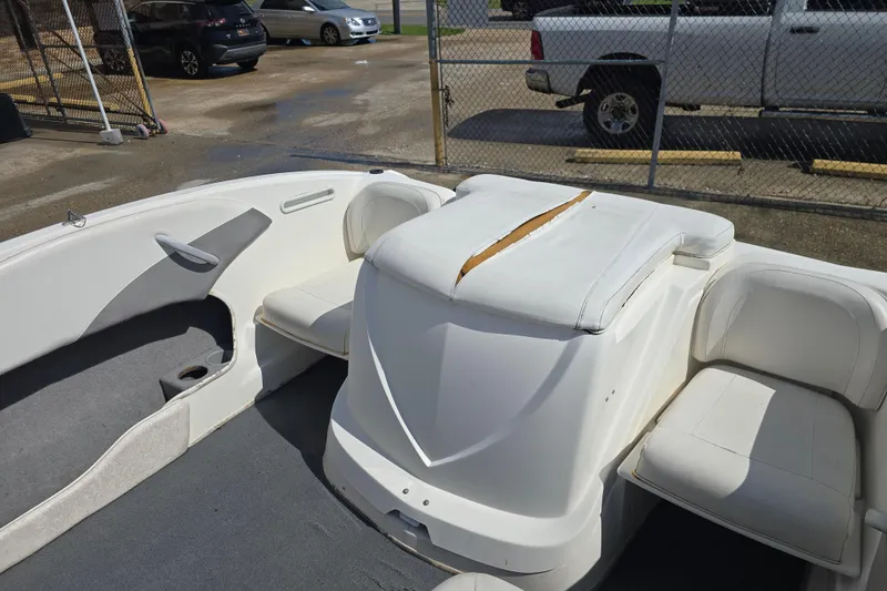 Slide: The Image of 2010 Bayliner 185 Bowrider interior with white seating and visible wear. - 12