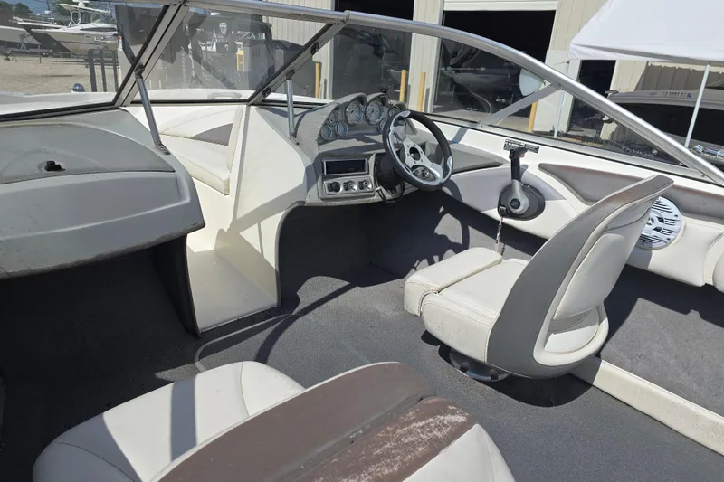 Slide: The Image of Interior of a 2010 Bayliner 185 Bowrider boat, featuring steering wheel and seating. - 9