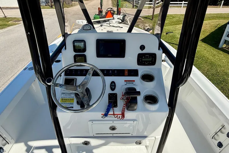 Slide: The Image of 2015 Sea Hunt RZR 24 boat console with steering wheel and navigation controls. - 11