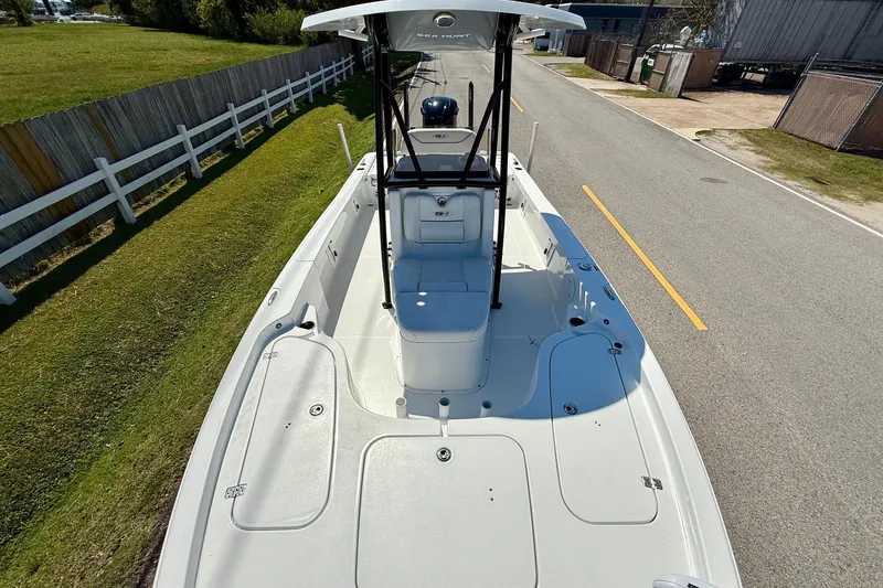 Slide: The Image of 2015 Sea Hunt RZR 24 boat on road, top view, white deck, T-top canopy. - 16