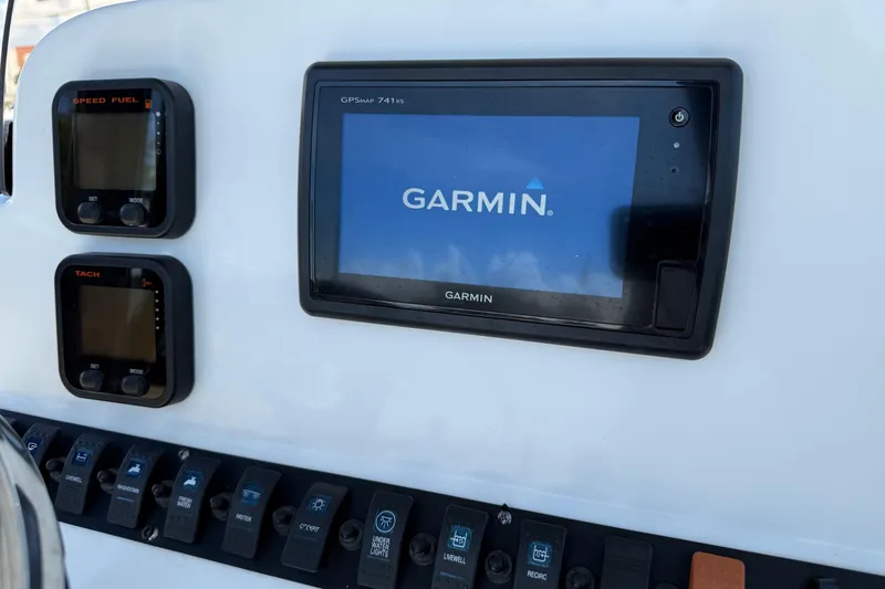 Slide: The Image of Dashboard of 2015 Sea Hunt RZR 24 with Garmin GPS and control switches. - 17