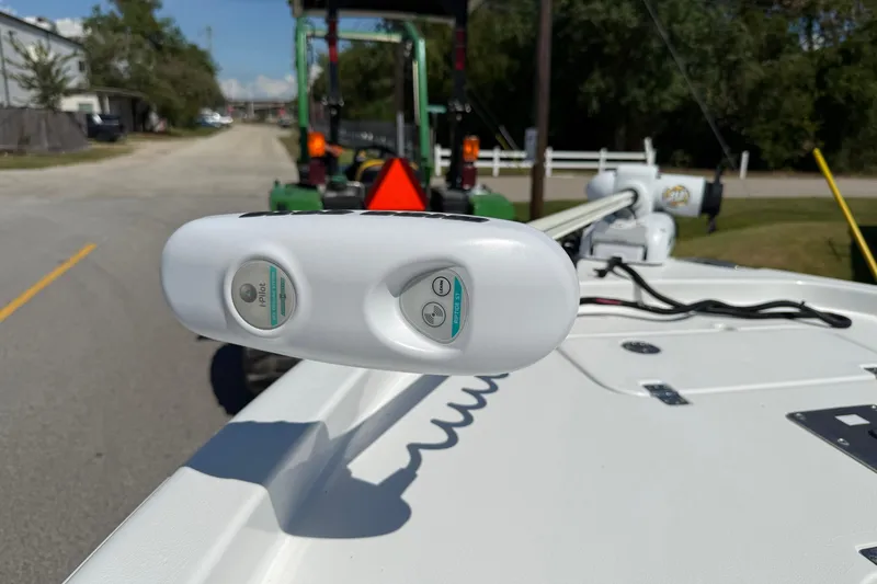 Slide: The Image of 2015 Sea Hunt RZR 24 boat with i-Pilot trolling motor on a sunny street. - 18