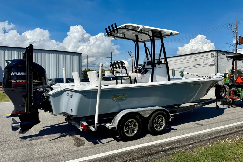 Slide: The Image of 2015 Sea Hunt RZR 24 boat on trailer, Yamaha engine, parked outdoors. - 4