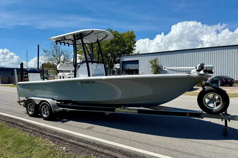 Slide: The Image of 2015 Sea Hunt RZR 24 boat on trailer, parked on roadside under clear blue sky. - 5