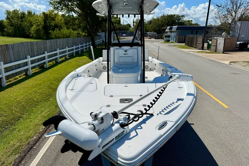 Slide: The Image of 2015 Sea Hunt RZR 24 boat on a road, featuring a trolling motor. - 6