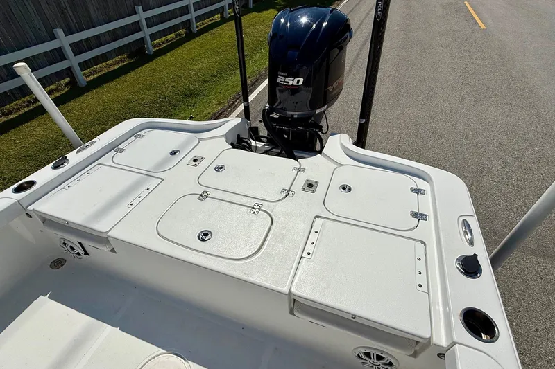 Slide: The Image of 2015 Sea Hunt RZR 24 boat deck with storage compartments and 250 horsepower outboard motor. - 8