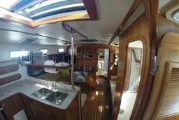 Slide: The Image of Interior of a 1999 Caliber 40LRC yacht with wooden finishes and modern amenities. - 12