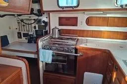 Slide: The Image of 1999 Caliber 40LRC yacht interior with stove and wooden cabinetry. - 15
