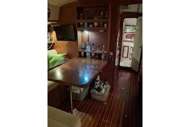 Slide: The Image of Interior of 1999 Caliber 40LRC yacht with wooden table and bar area. - 17