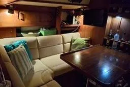 Slide: The Image of 1999 Caliber 40LRC yacht interior with cozy seating and wooden table. - 18