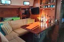 Slide: The Image of Interior of 1999 Caliber 40LRC yacht with cozy seating and wooden table. - 19