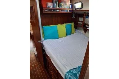 Slide: The Image of Cozy cabin interior of 1999 Caliber 40LRC sailboat with colorful pillows. - 24