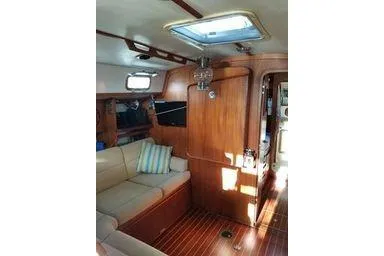Slide: The Image of Interior of 1999 Caliber 40LRC yacht with wooden finish and cozy seating area. - 26