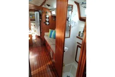 Slide: The Image of 1999 Caliber 40LRC yacht interior with wooden finish and cozy seating area. - 27