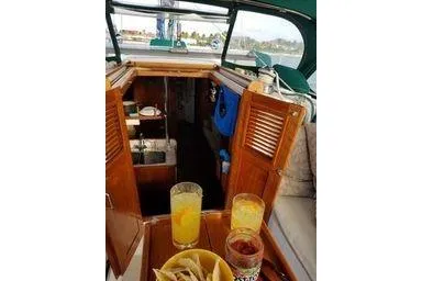 Slide: The Image of Interior view of 1999 Caliber 40LRC sailboat with snacks and drinks on table. - 32
