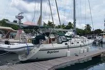 Slide: The Image of 1999 Caliber 40LRC sailboat docked at marina with clear skies and surrounding boats. - 34