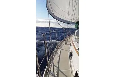 Slide: The Image of Sailing on a 1999 Caliber 40LRC yacht, ocean view, clear skies, and white sails. - 38