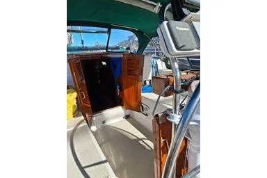 Slide: The Image of 1999 Caliber 40LRC yacht cockpit with wooden doors and steering wheel. - 4