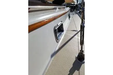 Slide: The Image of 1999 Caliber 40LRC sailboat deck with polished wood trim and stainless steel fittings. - 5