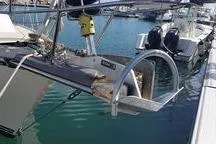 Slide: The Image of 1999 Caliber 40LRC sailboat docked in marina, featuring stainless steel arch and equipment. - 7