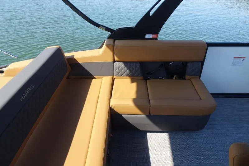 Slide: The Image of 2026 Harris Sunliner 250 boat interior with tan seating and quilted accents. - 12