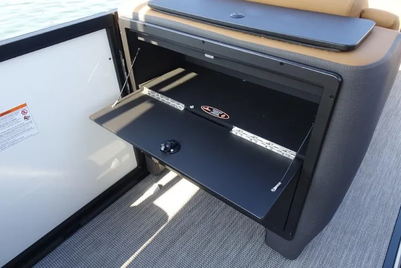 Slide: The Image of Open storage compartment on 2026 Harris Sunliner 250 boat, featuring sleek design and functionality. - 20