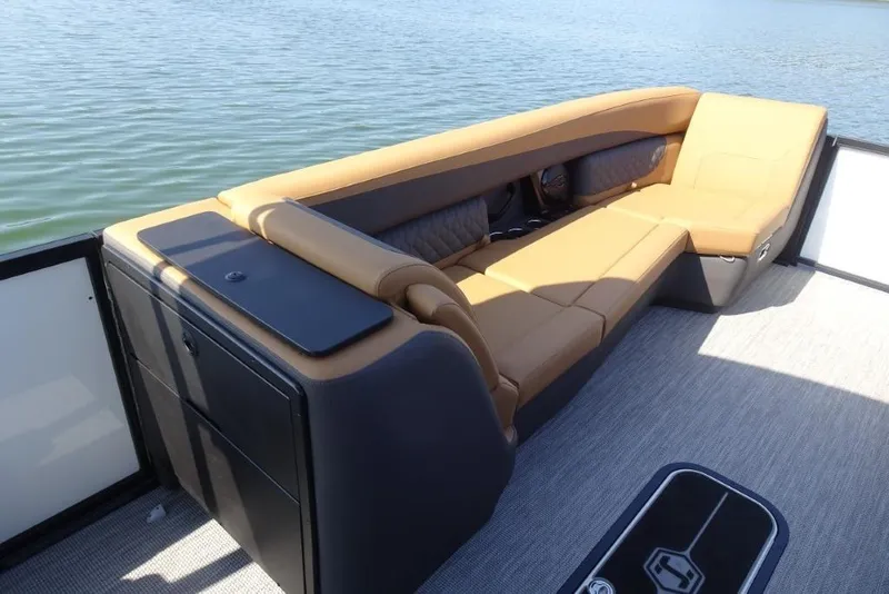 Slide: The Image of Luxurious seating on 2026 Harris Sunliner 250 pontoon boat, overlooking serene water. - 23