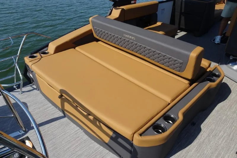 Slide: The Image of Luxurious seating on 2026 Harris Sunliner 250 boat with tan upholstery and cup holders. - 7