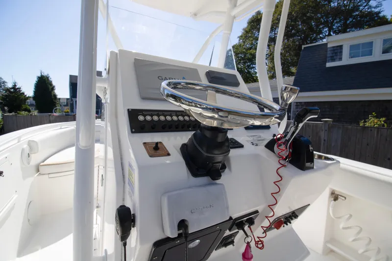 Slide: The Image of 2015 Edgewater 245CC boat console with steering wheel and navigation controls. - 10