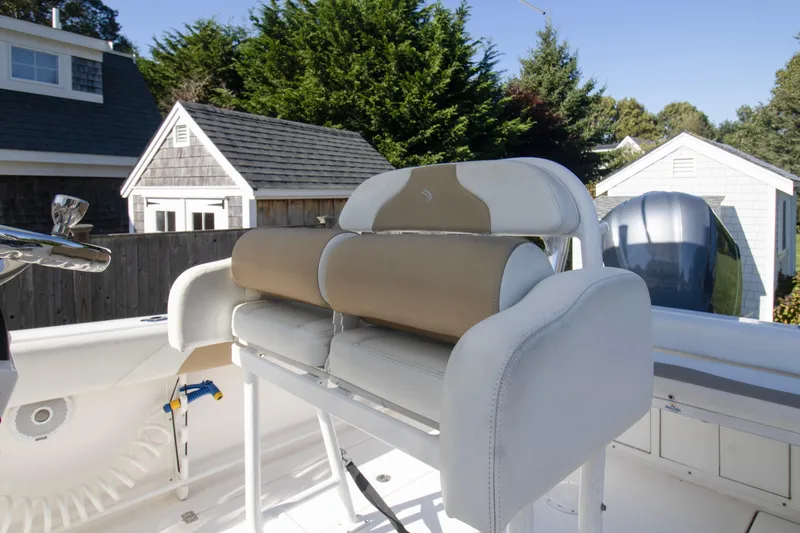 Slide: The Image of 2015 Edgewater 245CC boat interior with cushioned seating and steering wheel. - 12