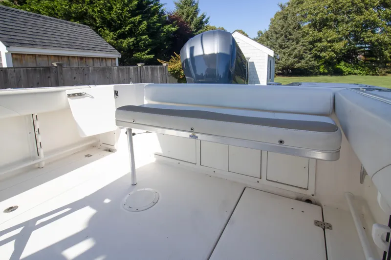 Slide: The Image of 2015 Edgewater 245CC boat interior with seating and storage compartments. - 14