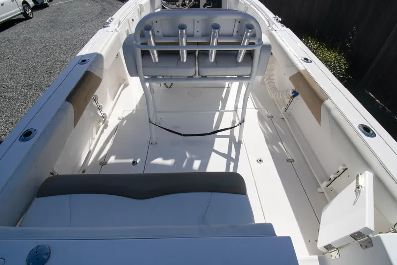 Slide: The Image of 2015 Edgewater 245CC boat interior with seating and rod holders, showcasing spacious deck layout. - 15